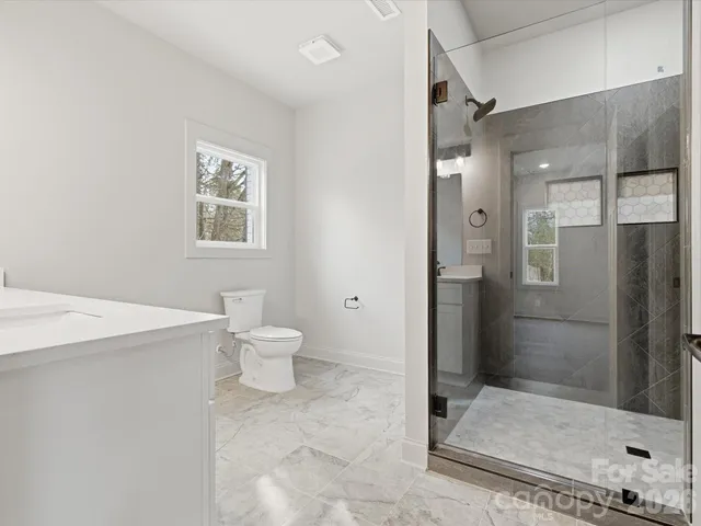 a bathroom with a toilet sink and shower