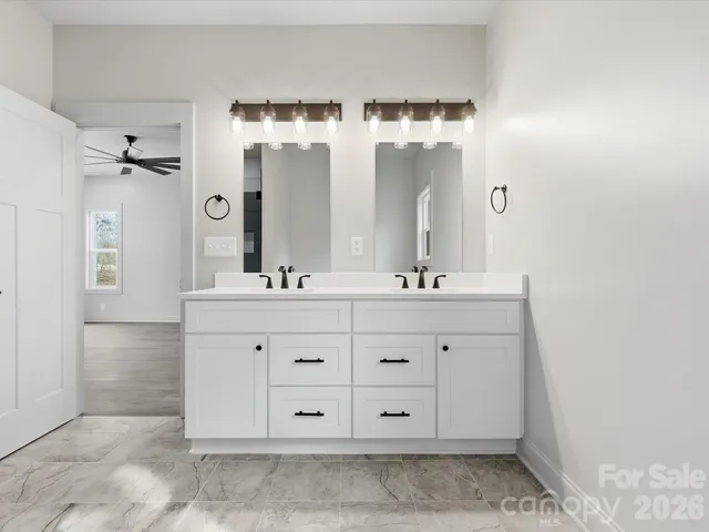 a bathroom with a double vanity sink mirror and double