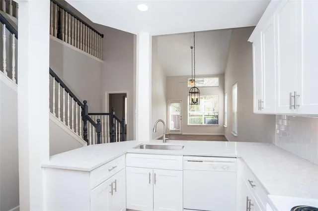 a kitchen with a sink cabinets appliances and a window