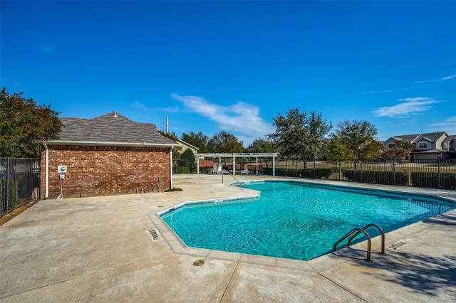 a view of a backyard with a garden and fire pit