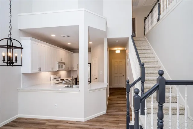 a view of kitchen with cabinets and wooden floor