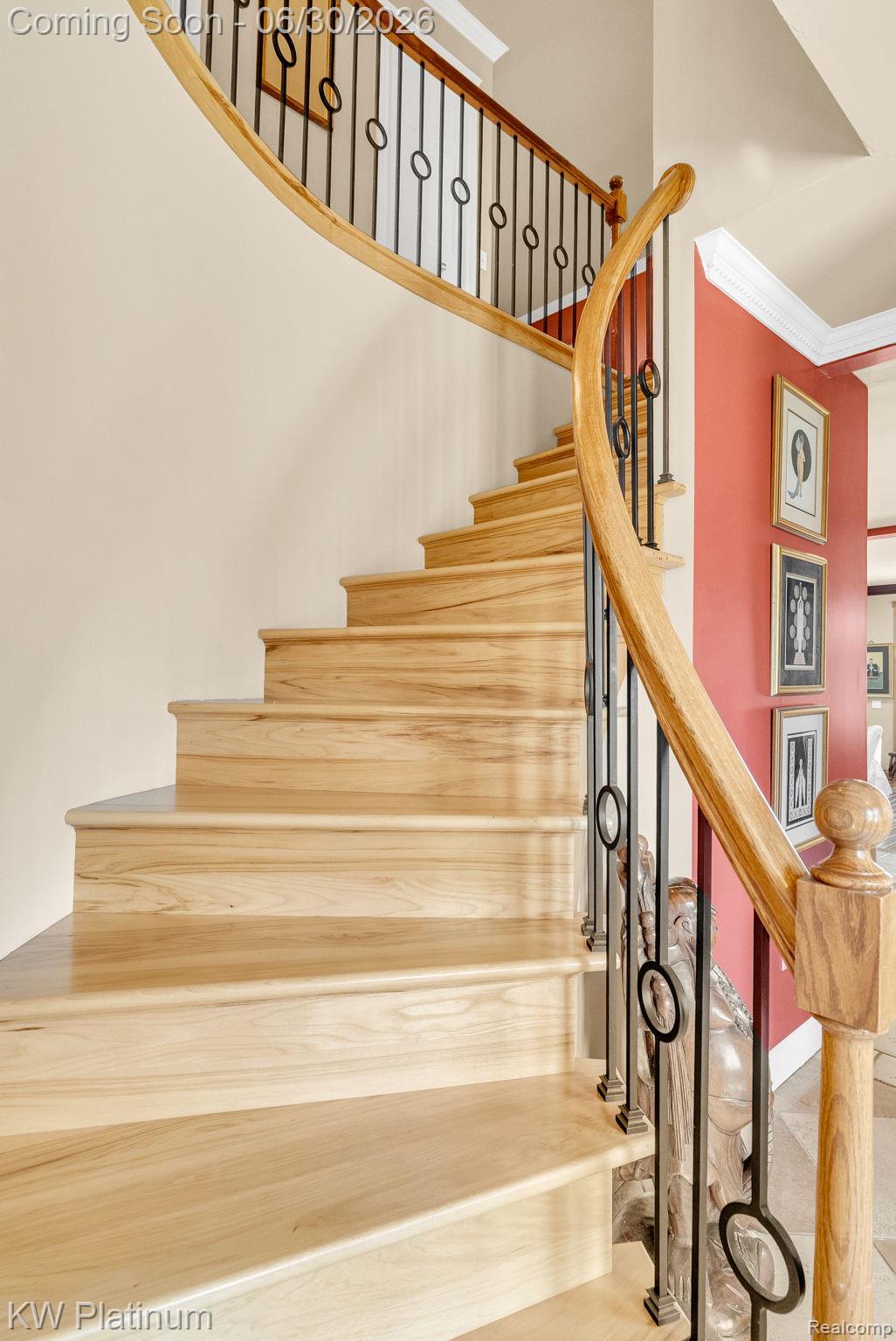 2235 South Lake Shore Road Harbor Beach, MI 48441 - Photo 27 of 99 Curved staircase featuring natural wood treads and risers, a wood handrail, and wrought iron balusters with circular accents