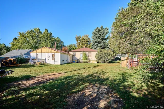a front view of a house with a yard and trees