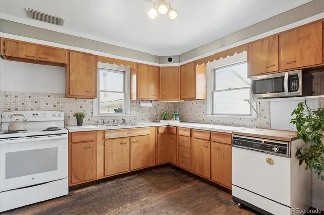 a kitchen with a sink stove and cabinets