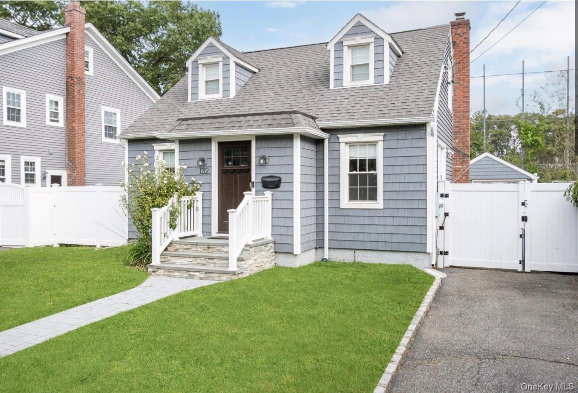 132 Webster Street Merrick, NY 11566 - Photo 2 of 28 a front view of a house with a yard and garage