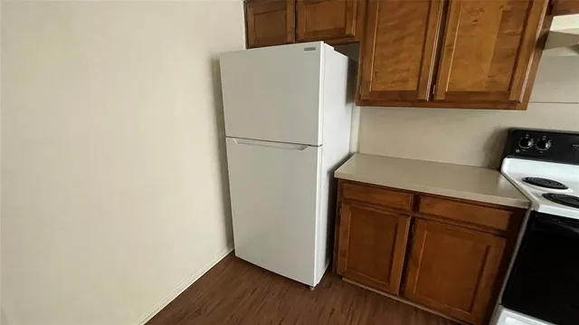 a white refrigerator freezer sitting inside of a kitchen