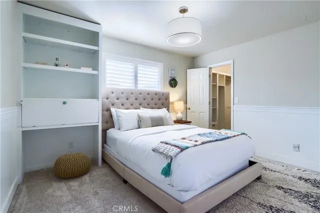 a en suite bathroom with a granite countertop sink and a mirror