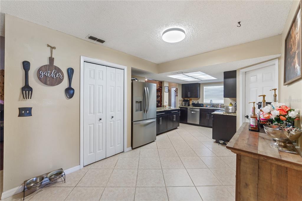 8715 Huntsman Lane Port Richey, FL 34668 - Photo 11 of 54 a large white kitchen with a lot of cabinets and refrigerator