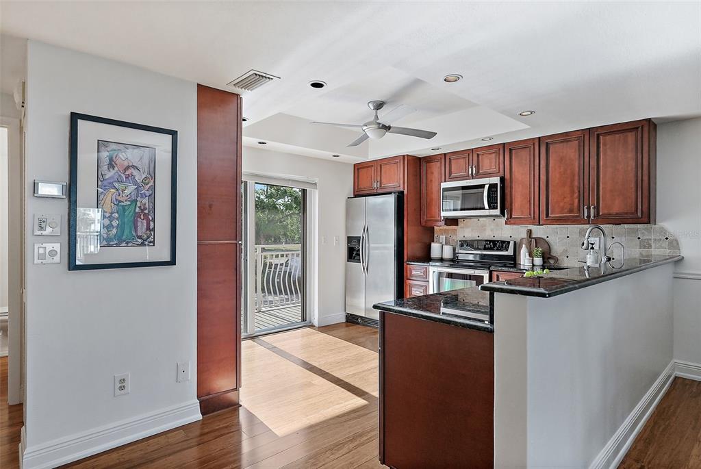 936 Pinellas Bayway South, Unit T5 Tierra Verde, FL 33715 - Photo 12 of 38 a kitchen with stainless steel appliances granite countertop a refrigerator a stove top oven a sink and dishwasher