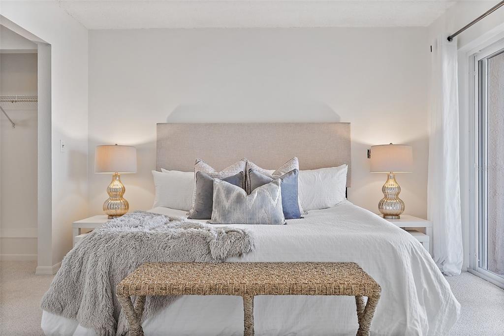 936 Pinellas Bayway South, Unit T5 Tierra Verde, FL 33715 - Photo 14 of 38 a large bed sitting in a bedroom next to a lamp