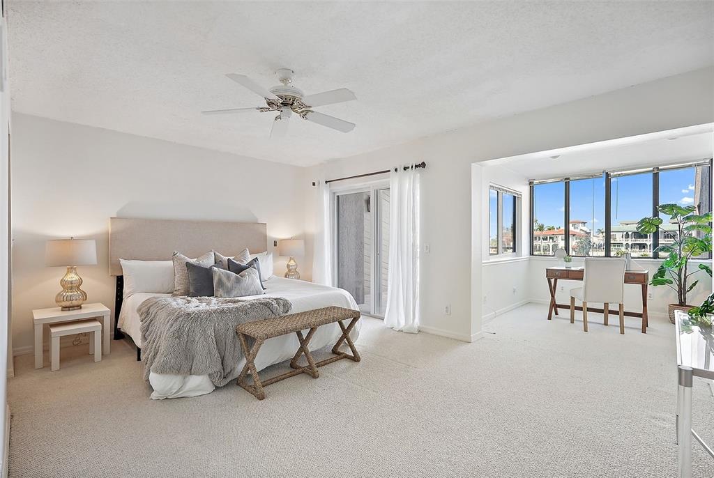 936 Pinellas Bayway South, Unit T5 Tierra Verde, FL 33715 - Photo 15 of 38 a bedroom with a bed furniture and a window