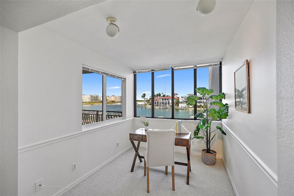 936 Pinellas Bayway South, Unit T5 Tierra Verde, FL 33715 - Photo 18 of 38 a dining room with furniture potted plants and wooden floor