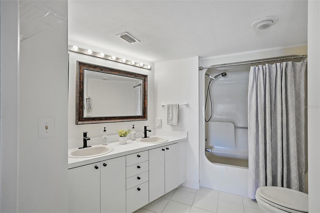 936 Pinellas Bayway South, Unit T5 Tierra Verde, FL 33715 - Photo 19 of 38 a bathroom with a double vanity sink mirror double and shower