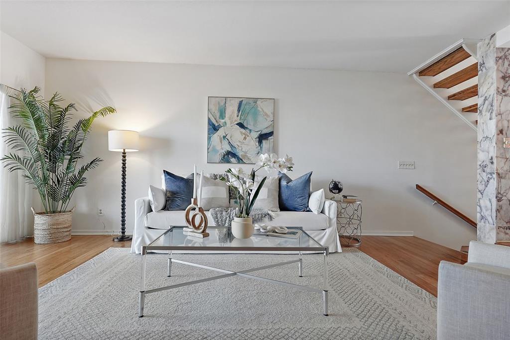 936 Pinellas Bayway South, Unit T5 Tierra Verde, FL 33715 - Photo 7 of 38 a living room with furniture and potted plants on table