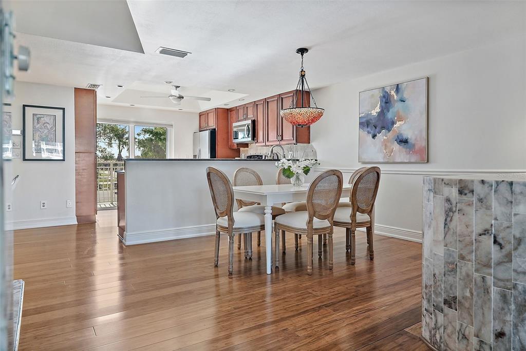 936 Pinellas Bayway South, Unit T5 Tierra Verde, FL 33715 - Photo 8 of 38 a view of a dining room with furniture window and wooden floor