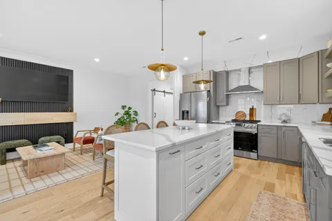 a kitchen with stainless steel appliances kitchen island granite countertop a sink and cabinets