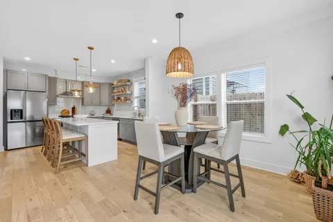 a view of a dining room with furniture window and wooden floor