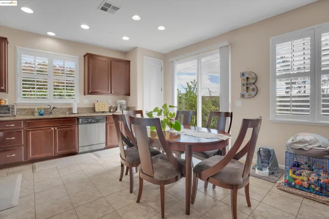 a view of a dining room with furniture and windows