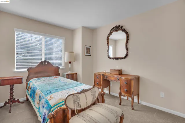 a bedroom with a bed and a mirror