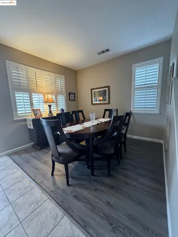 a view of a dining room with furniture and window