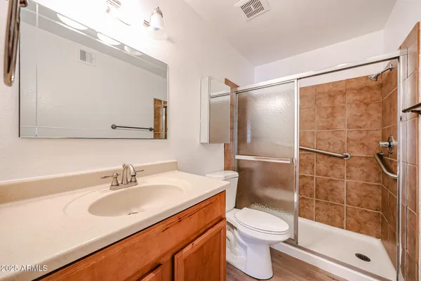 a bathroom with a sink toilet and shower
