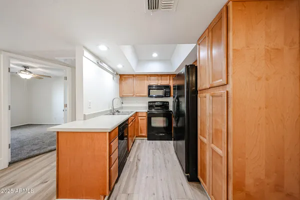 a kitchen with stainless steel appliances granite countertop a refrigerator and a sink