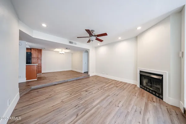 wooden floor in an empty room with a fireplace
