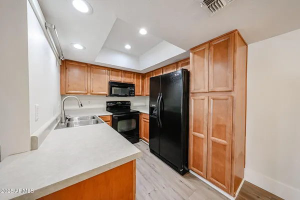 a kitchen with stainless steel appliances a refrigerator sink and microwave