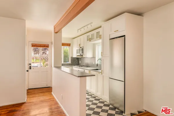 a kitchen with stainless steel appliances a refrigerator and a stove