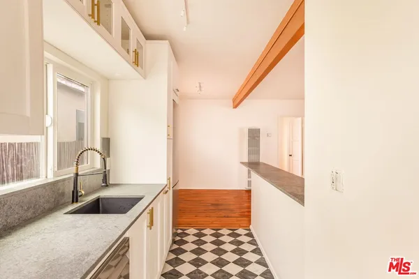a kitchen with granite countertop a sink and a stove
