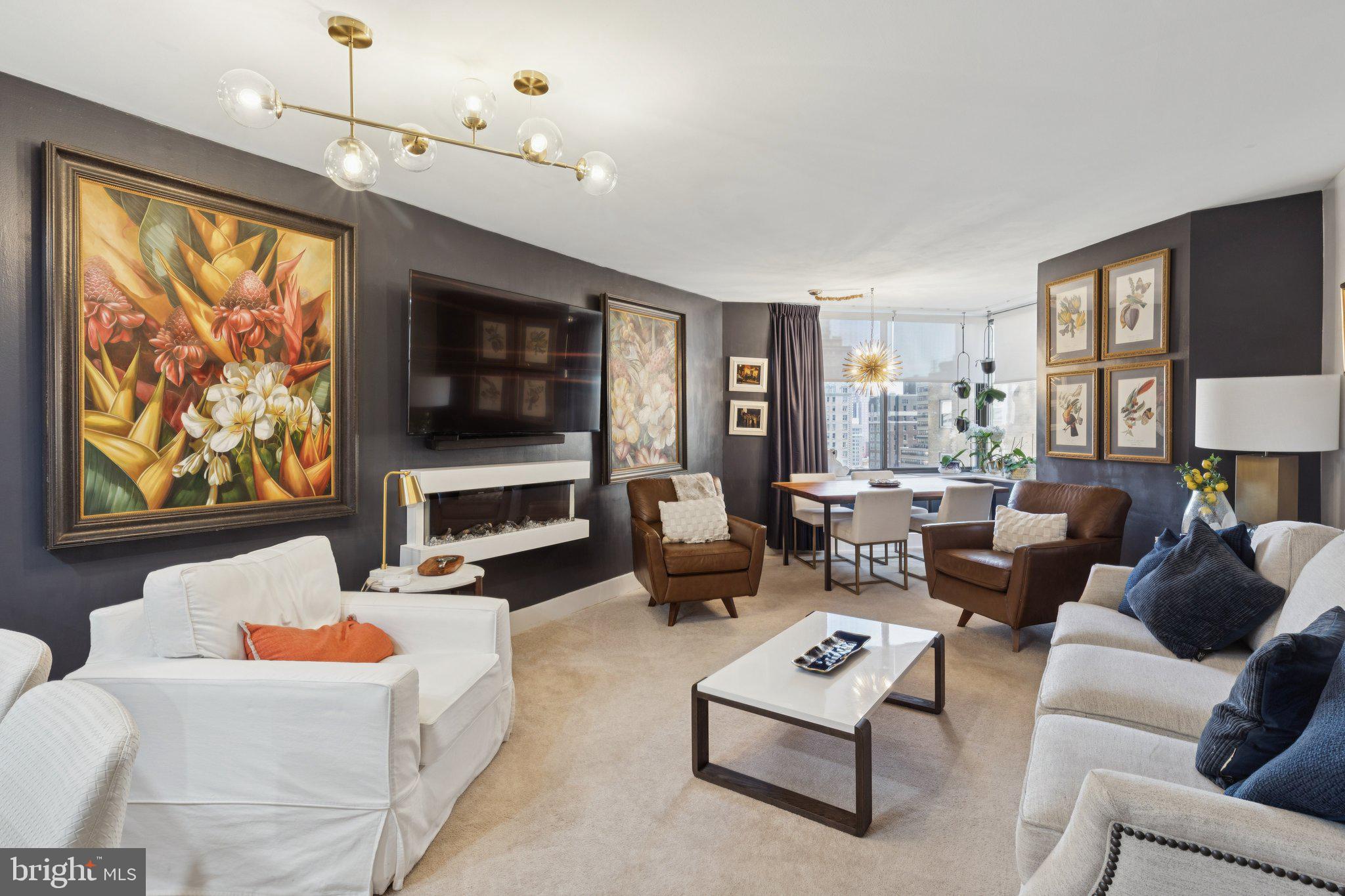 202 West Rittenhouse Square, Unit 1409 Philadelphia, PA 19103 - Photo 1 of 39 a living room with furniture flat screen tv and a large window