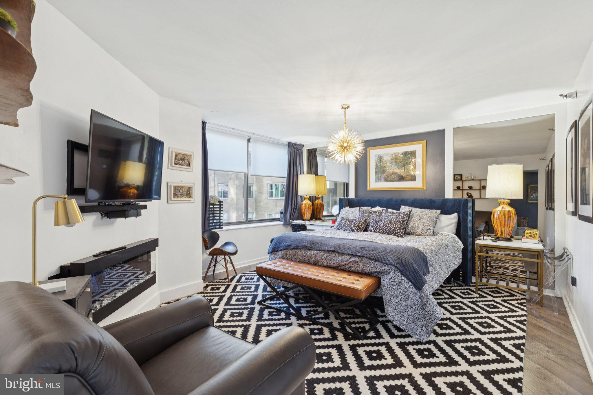 202 West Rittenhouse Square, Unit 1409 Philadelphia, PA 19103 - Photo 13 of 39 a living room with furniture and a flat screen tv