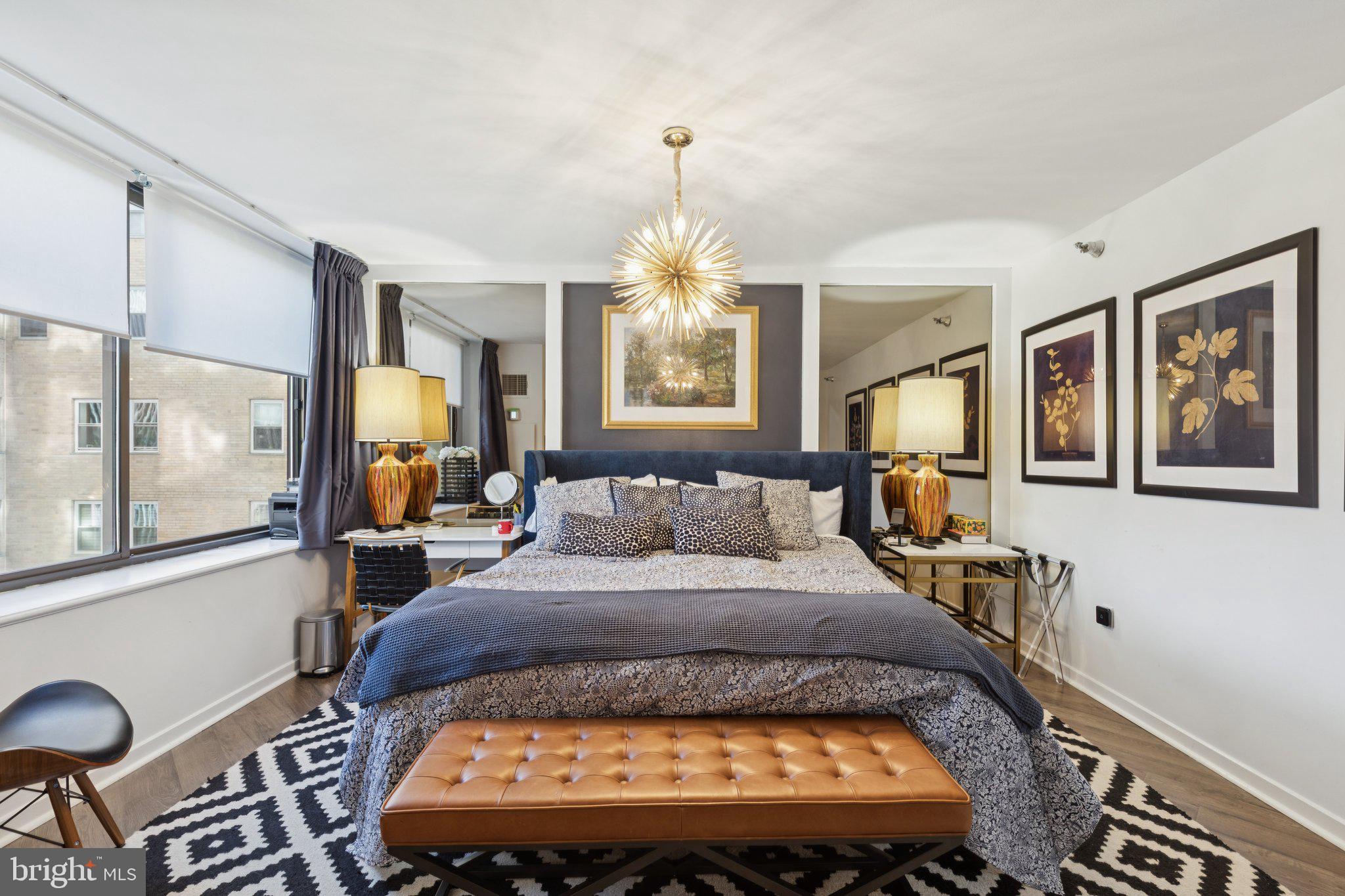 202 West Rittenhouse Square, Unit 1409 Philadelphia, PA 19103 - Photo 14 of 39 a bed sitting in a bedroom next to a window