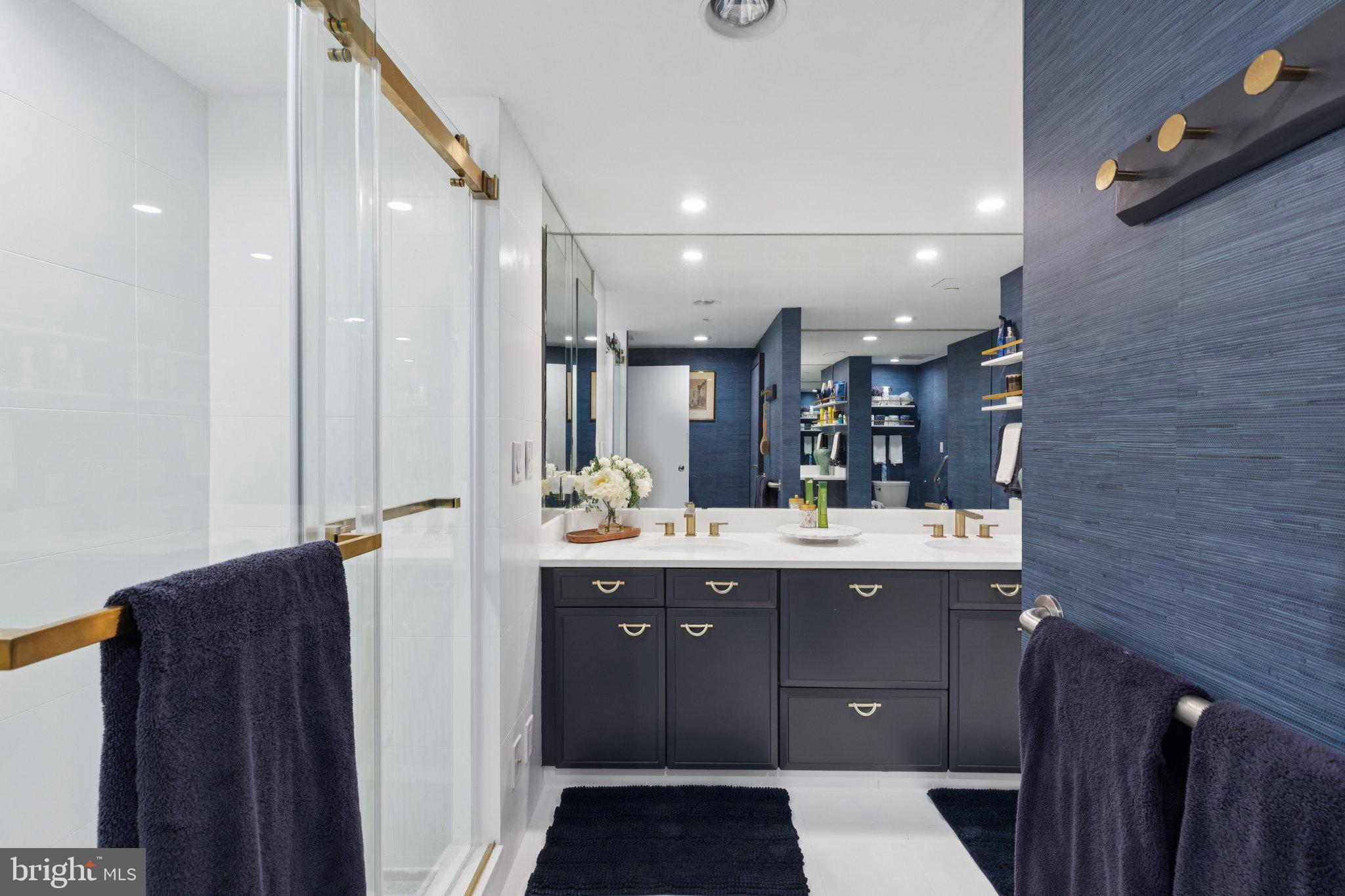 202 West Rittenhouse Square, Unit 1409 Philadelphia, PA 19103 - Photo 16 of 39 a view of a bathroom with a sink and mirror