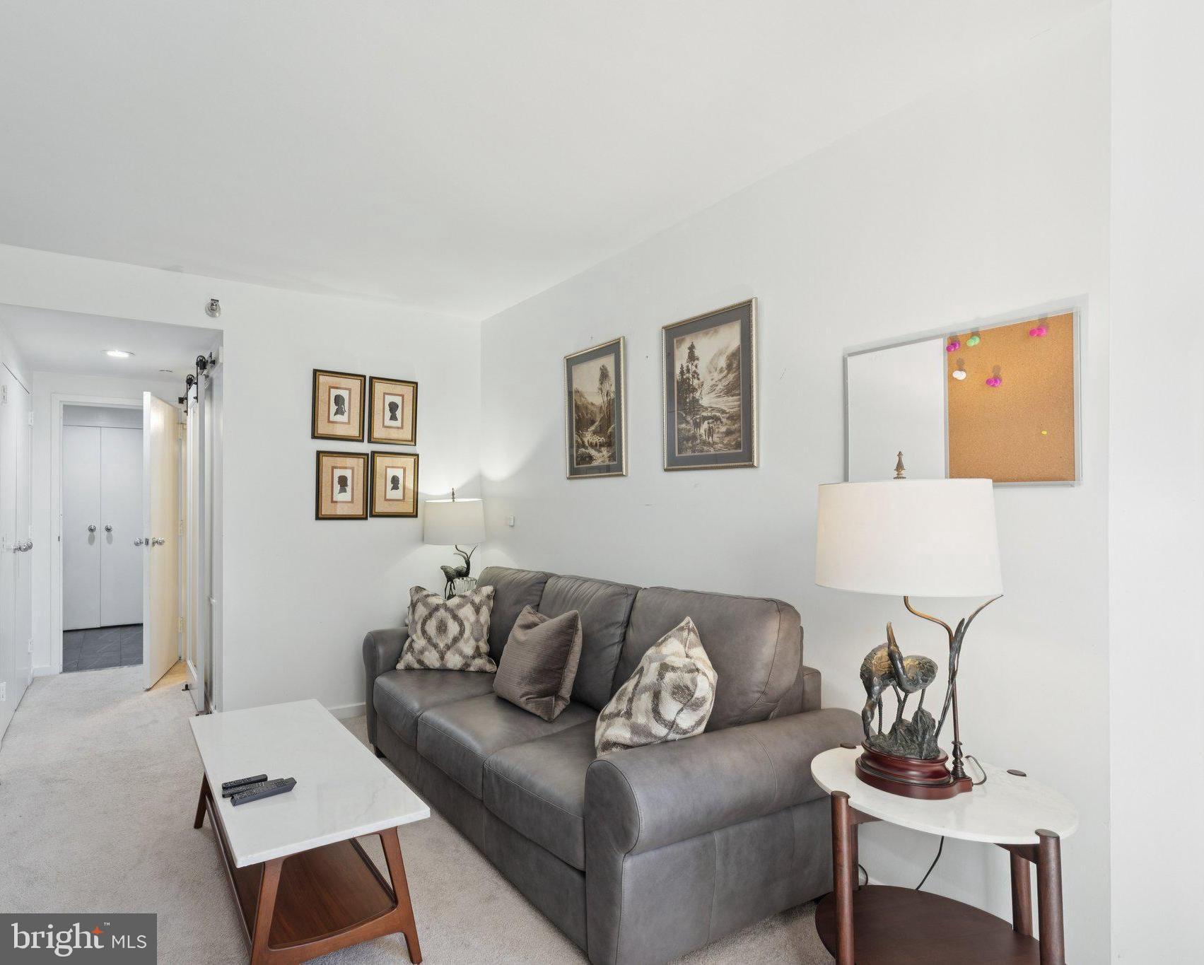202 West Rittenhouse Square, Unit 1409 Philadelphia, PA 19103 - Photo 21 of 39 a living room with furniture and a potted plant