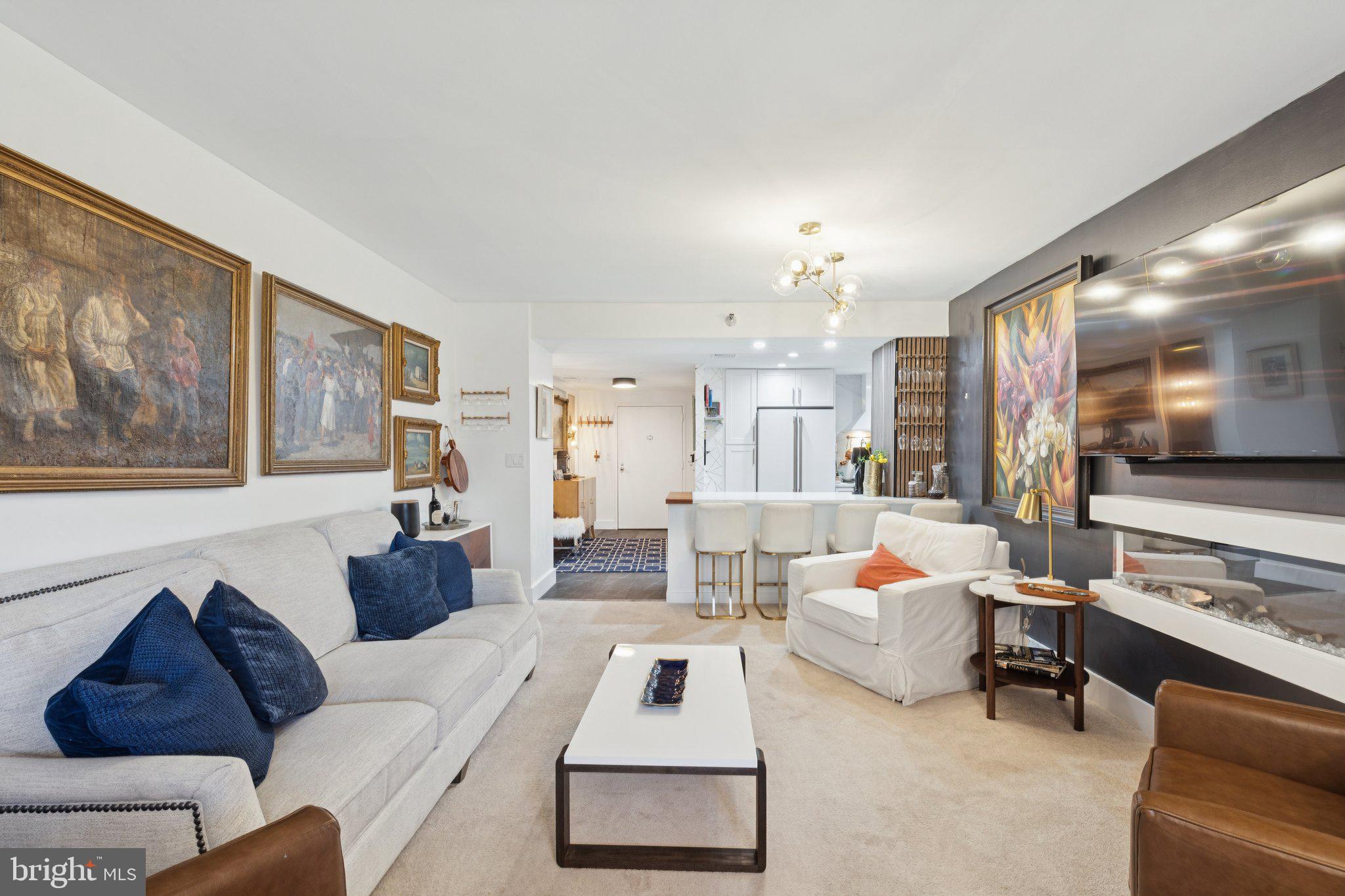 202 West Rittenhouse Square, Unit 1409 Philadelphia, PA 19103 - Photo 6 of 39 a living room with furniture and a flat screen tv