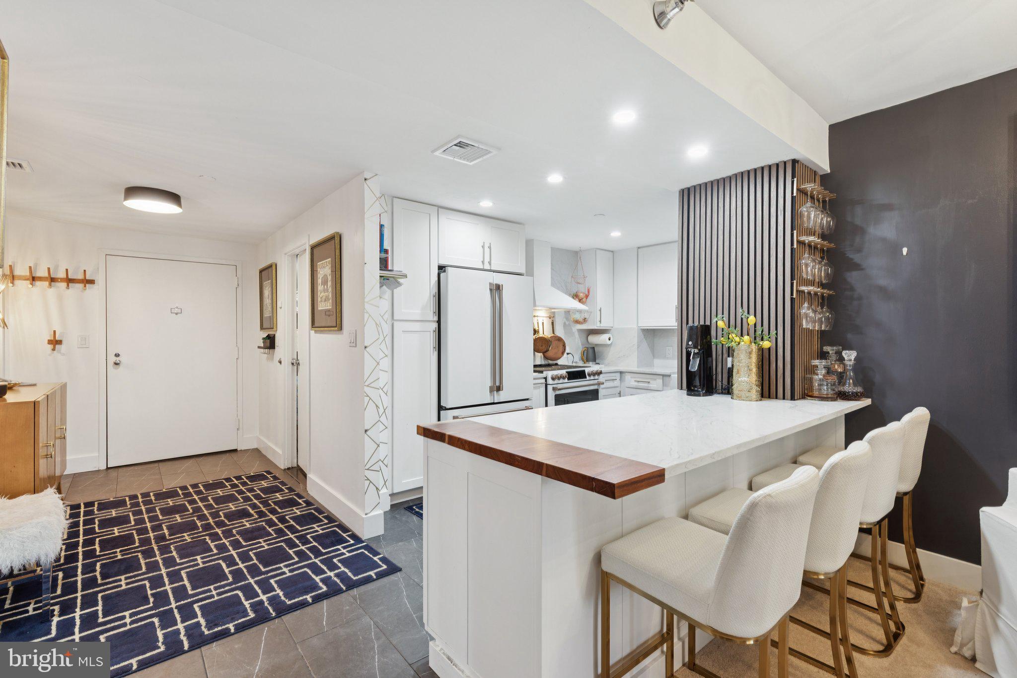 202 West Rittenhouse Square, Unit 1409 Philadelphia, PA 19103 - Photo 7 of 39 a kitchen with stainless steel appliances a refrigerator and a stove top oven