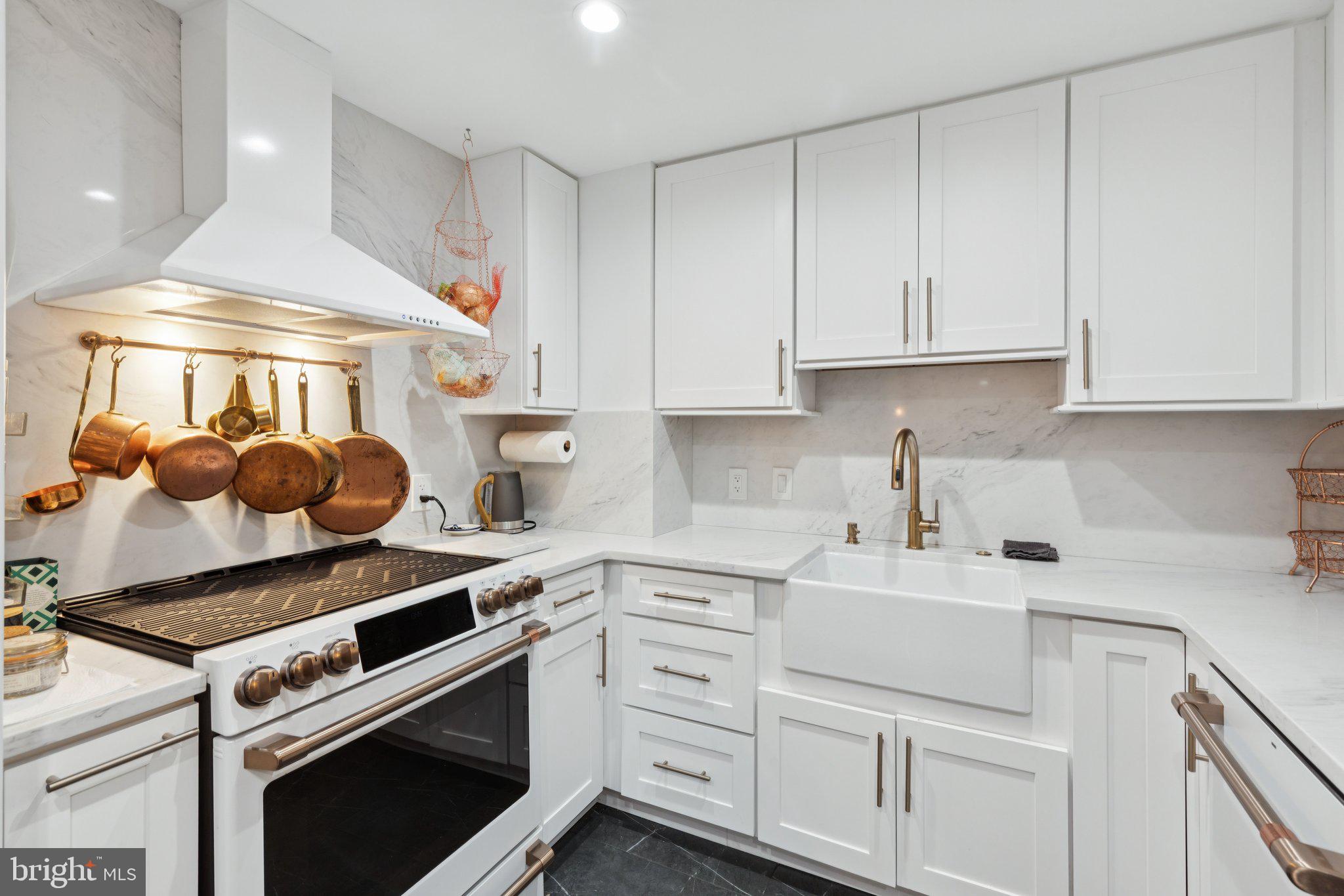 202 West Rittenhouse Square, Unit 1409 Philadelphia, PA 19103 - Photo 10 of 39 a kitchen with white cabinets and appliances