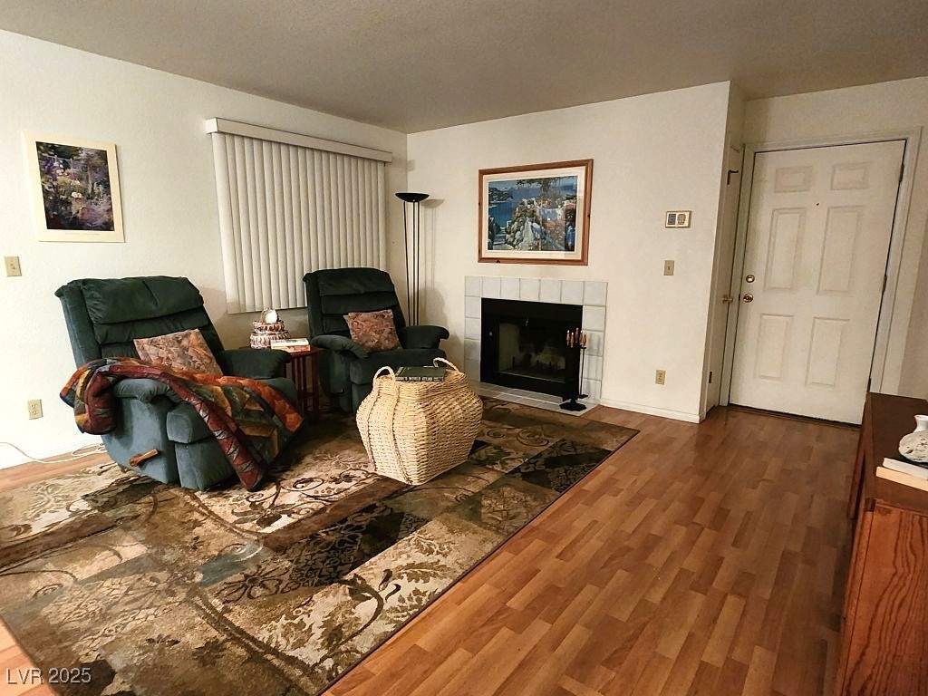 1964 Las Palmas Lane, Unit 141 Laughlin, NV 89029 - Photo 2 of 12 Living room with a tiled fireplace and wood finished floors