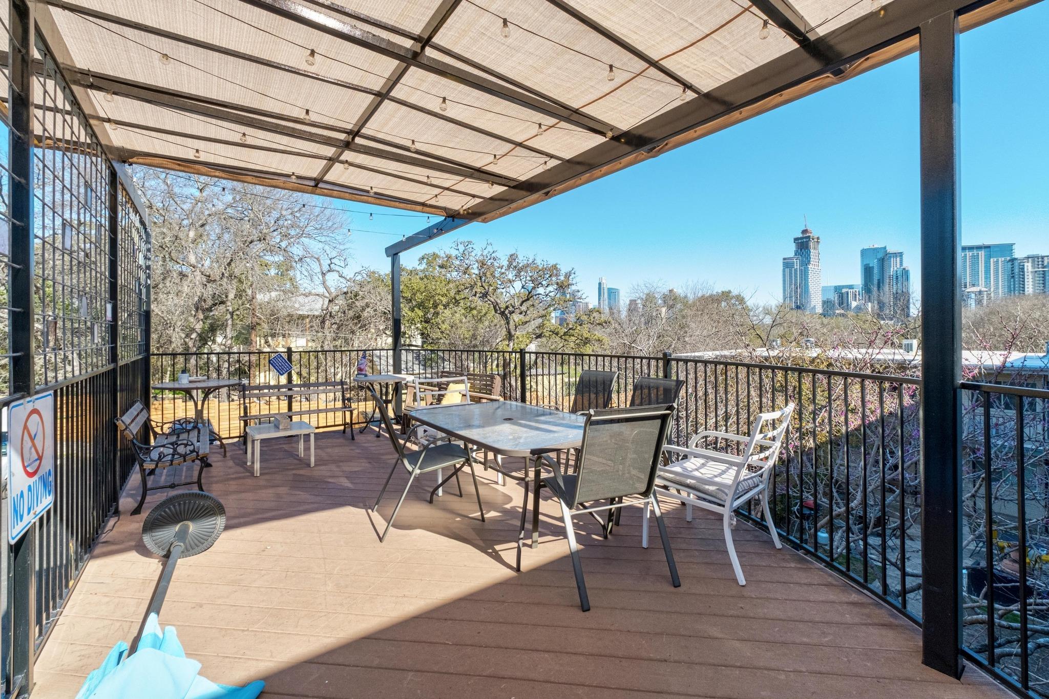 1202 Newning Avenue, Unit 207 Austin, TX 78704 - Photo 15 of 17 a view of a balcony with chairs and wooden floor