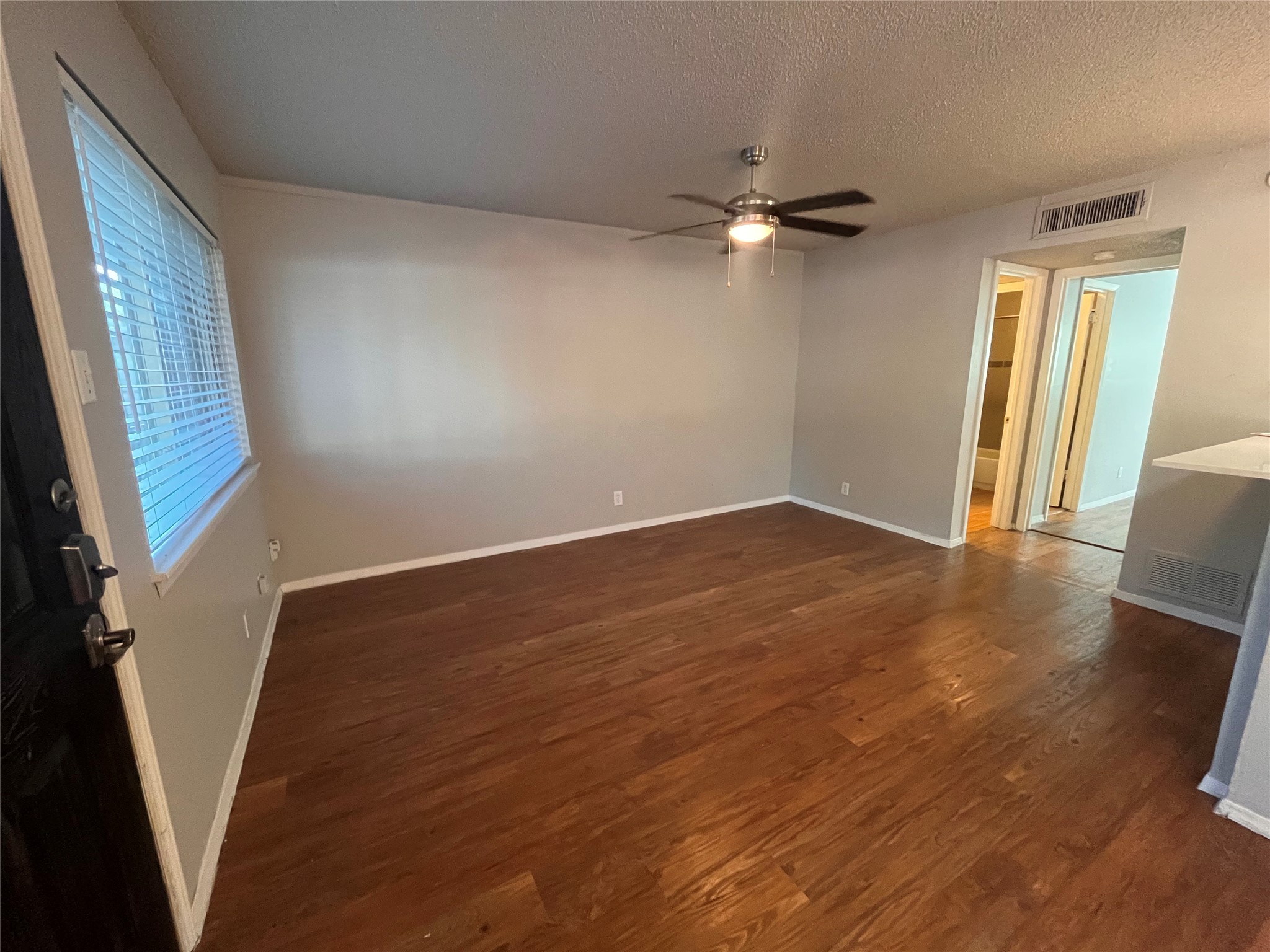 1202 Newning Avenue, Unit 207 Austin, TX 78704 - Photo 5 of 17 a view of empty room with wooden floor and fan