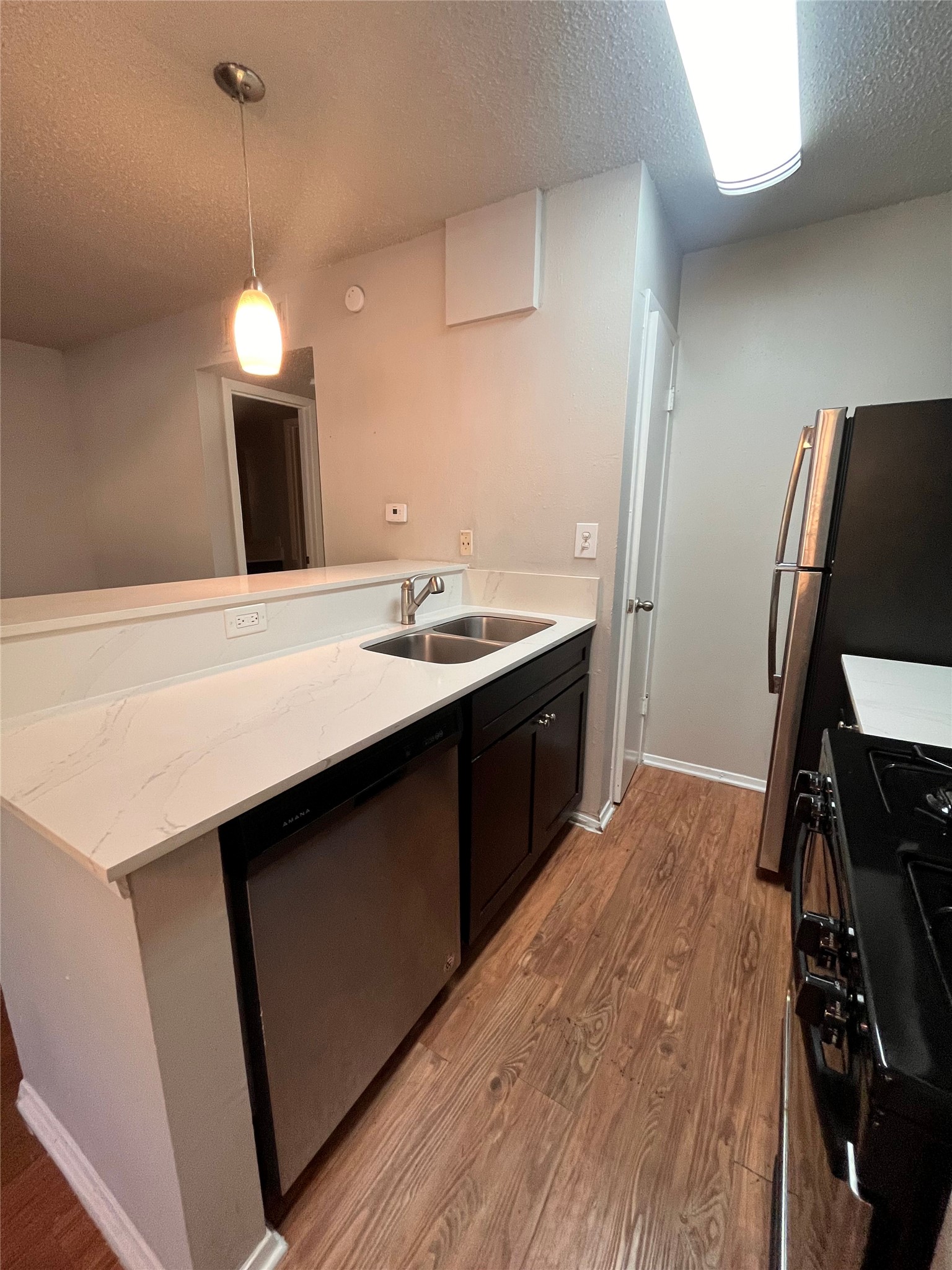 1202 Newning Avenue, Unit 207 Austin, TX 78704 - Photo 7 of 17 a kitchen with a sink stove and cabinets