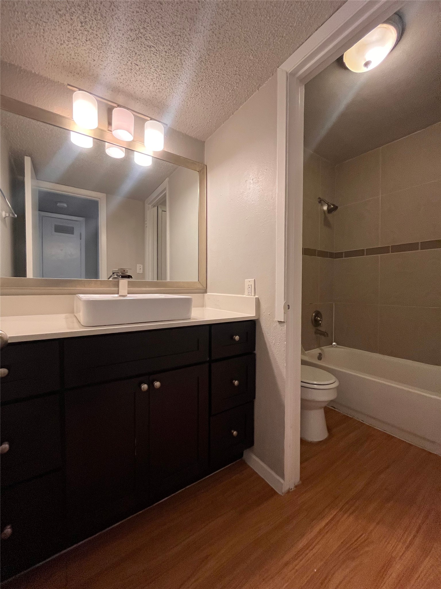 1202 Newning Avenue, Unit 207 Austin, TX 78704 - Photo 9 of 17 a bathroom with a double vanity sink and a toilet