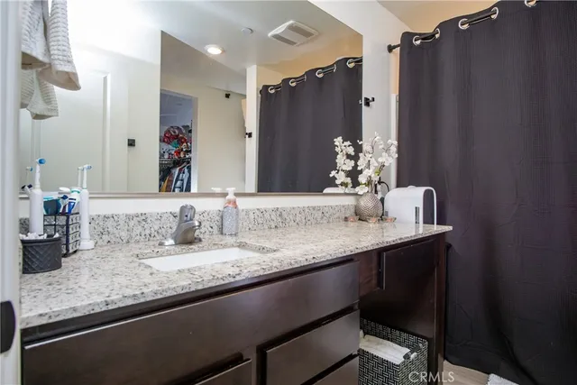 a bed room with a bed a flat screen tv and a window