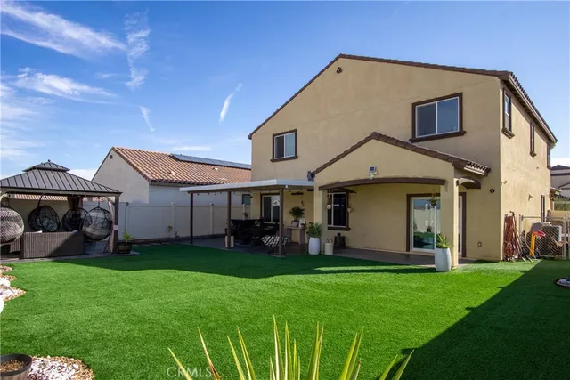 a front view of a house with yard furniture and a garage