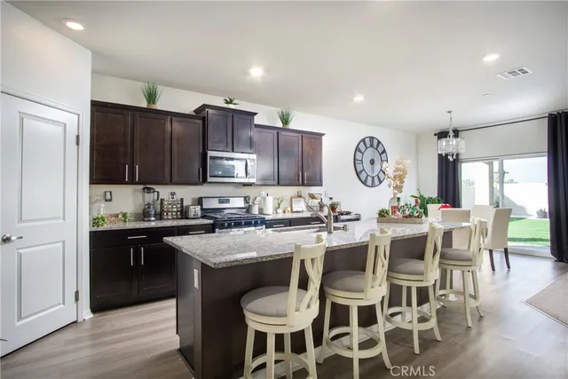 a living room with furniture a chandelier and a window