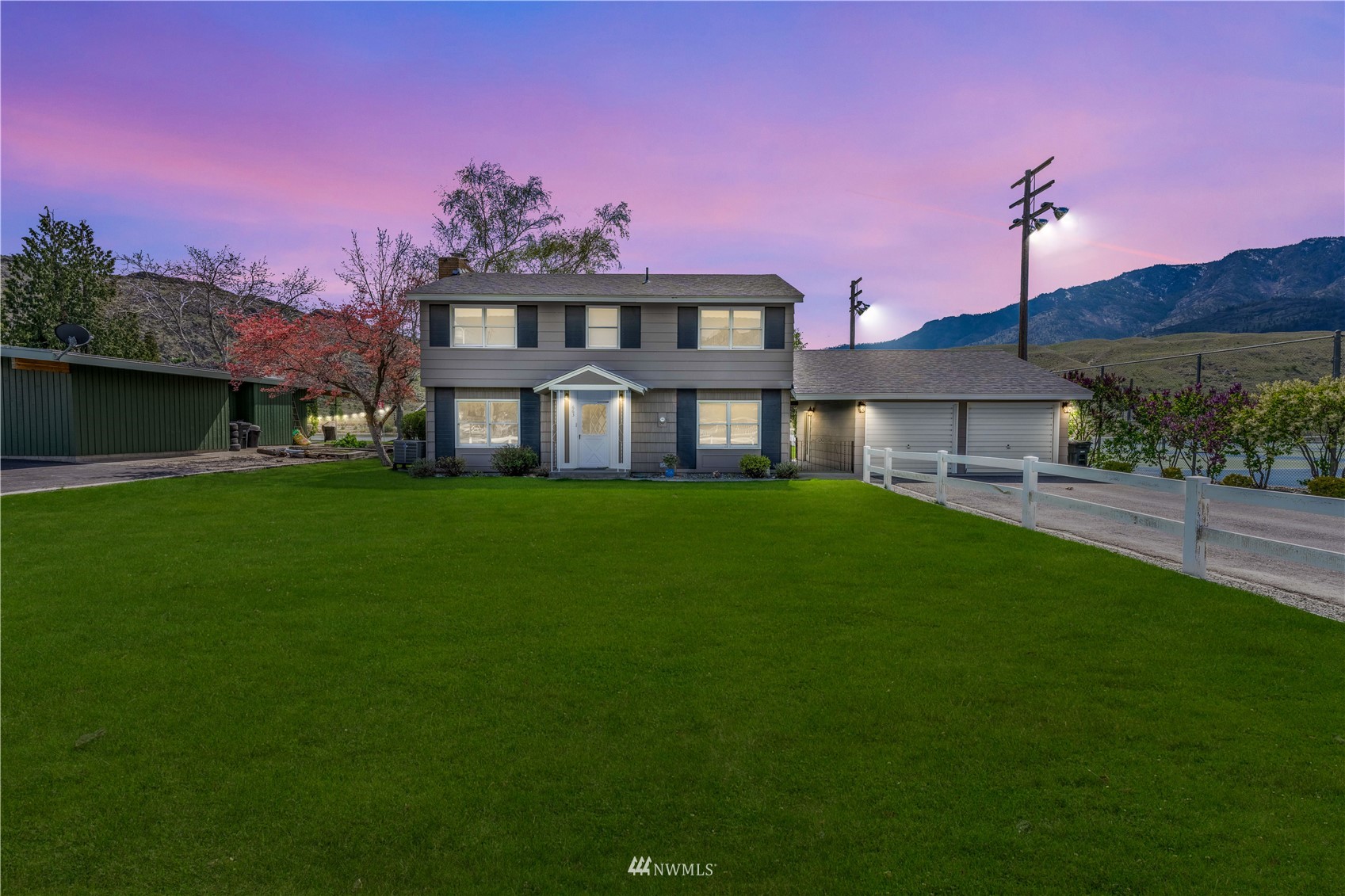 a front view of a house with a garden and yard