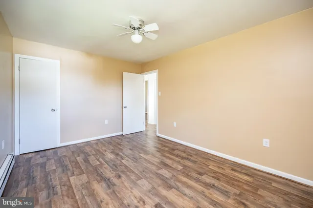a view of an empty room with wooden floor