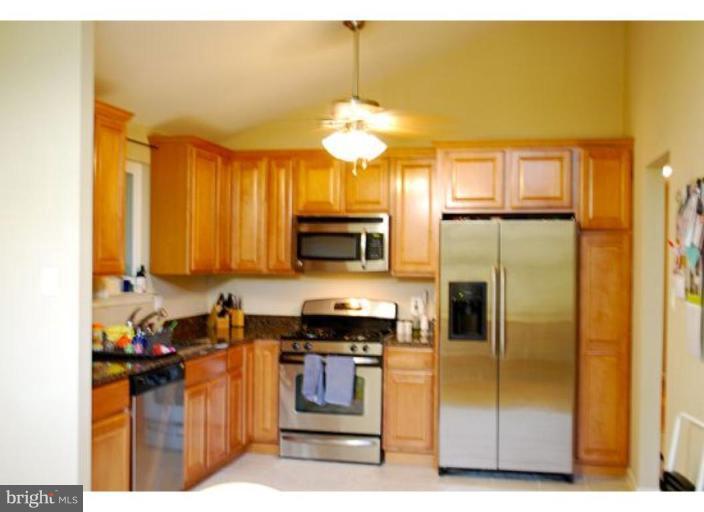 5529 Callander Drive Springfield, VA 22151 - Photo 3 of 30 a kitchen with stainless steel appliances granite countertop a refrigerator a stove and a sink