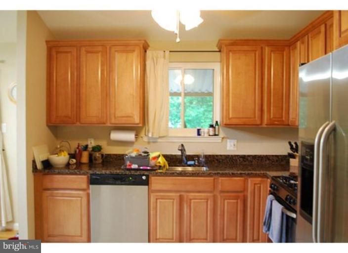 5529 Callander Drive Springfield, VA 22151 - Photo 4 of 30 a kitchen with stainless steel appliances granite countertop a refrigerator sink and cabinets